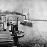 Historic black and white picture of ship coming into the port 